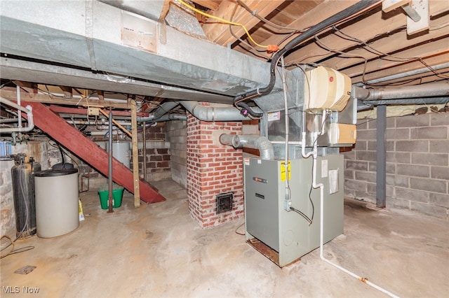 basement with water heater and heating unit