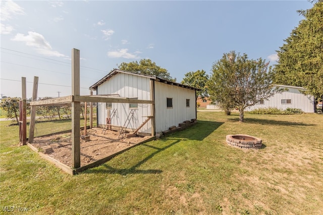 view of yard featuring a storage unit and a fire pit