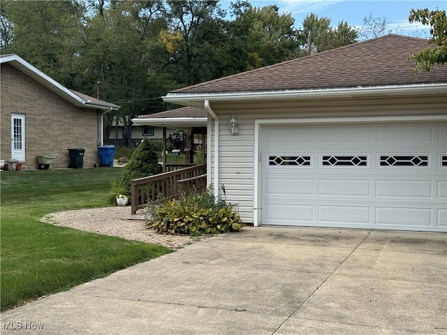 garage featuring a lawn