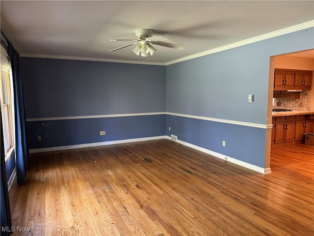 unfurnished room featuring crown molding, hardwood / wood-style flooring, and ceiling fan