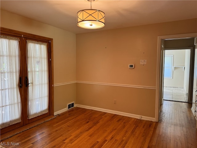 unfurnished room with wood-type flooring