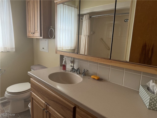 bathroom with toilet, tile patterned flooring, vanity, tasteful backsplash, and curtained shower