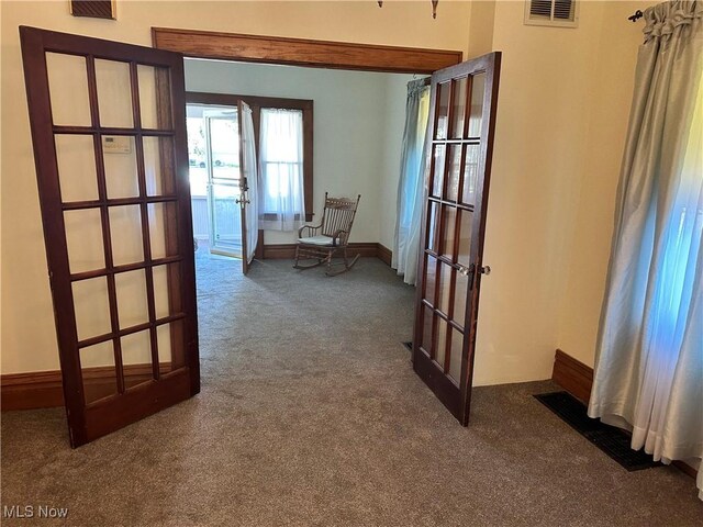 hall featuring carpet and french doors