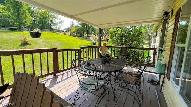 wooden terrace with a lawn