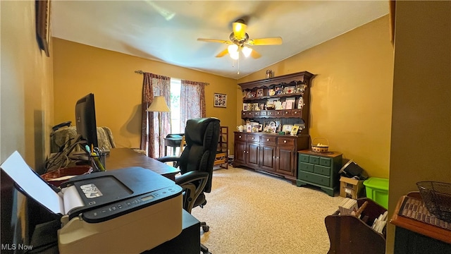 office featuring light carpet, vaulted ceiling, and ceiling fan