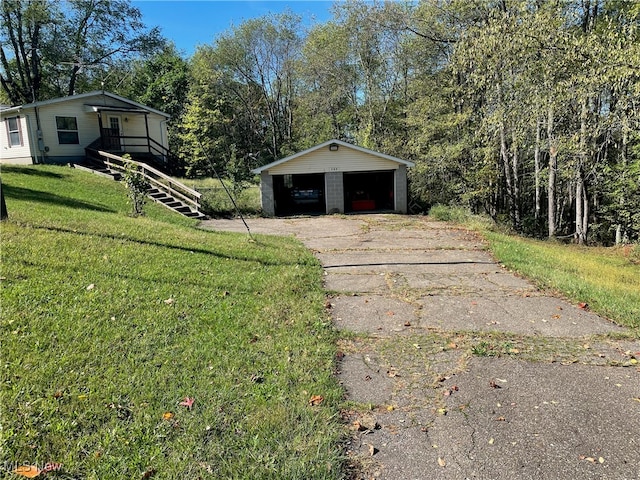 exterior space with an outbuilding, a carport, and a garage