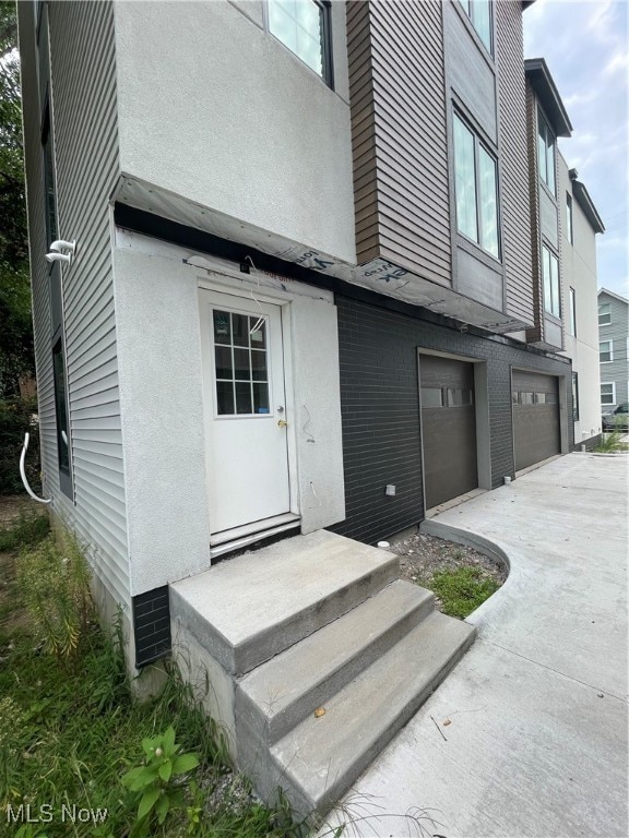 view of exterior entry featuring a garage