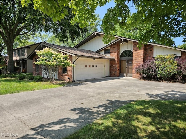 mid-century inspired home with brick siding, a front lawn, concrete driveway, and a garage