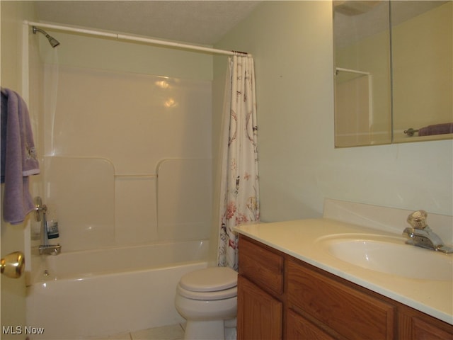 full bathroom featuring toilet, tile patterned floors, vanity, a textured ceiling, and shower / bath combo with shower curtain