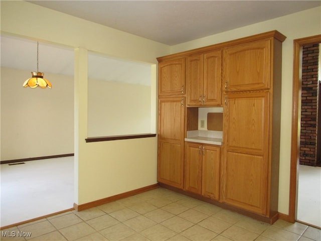 kitchen featuring decorative light fixtures and light colored carpet