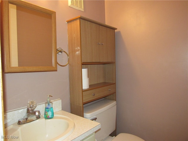 bathroom featuring vanity and toilet