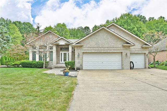 view of front of property with a garage and a front yard