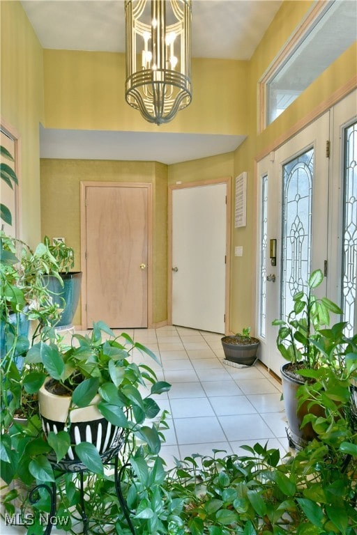 tiled entrance foyer featuring a chandelier