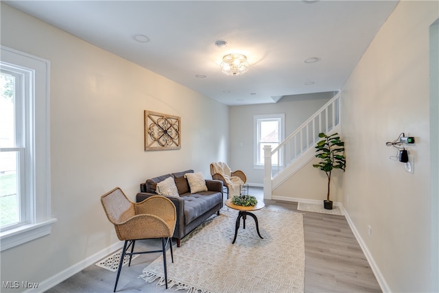 living area featuring plenty of natural light and light hardwood / wood-style flooring