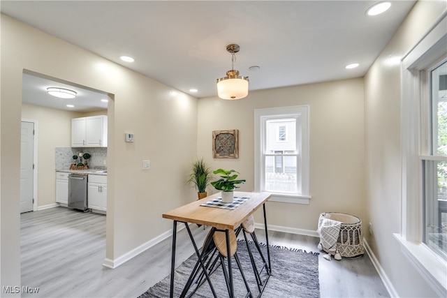 dining room featuring a wealth of natural light and light hardwood / wood-style flooring