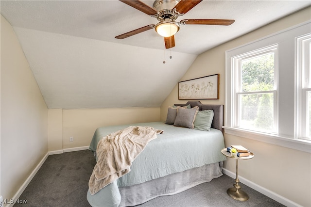 bedroom featuring ceiling fan, carpet, a textured ceiling, and vaulted ceiling