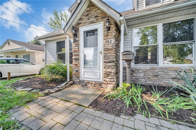 view of exterior entry with stone siding