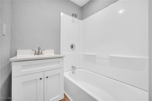 bathroom featuring shower / washtub combination and vanity