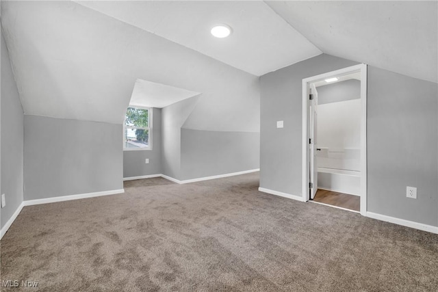 bonus room with vaulted ceiling, baseboards, and carpet floors