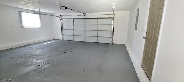 garage with baseboards and a garage door opener