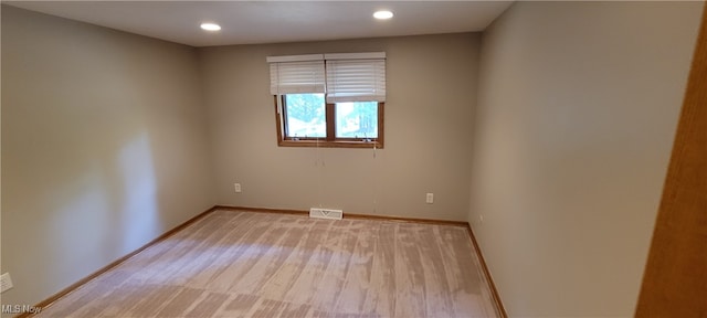 spare room with hardwood / wood-style floors