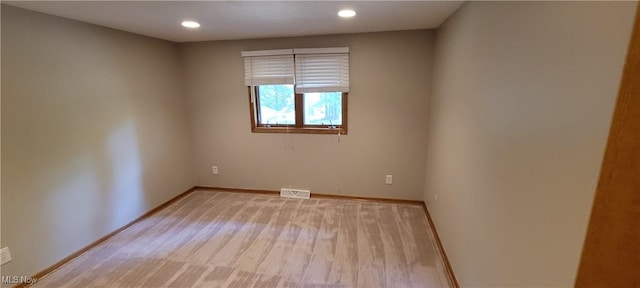 spare room featuring recessed lighting, visible vents, and baseboards