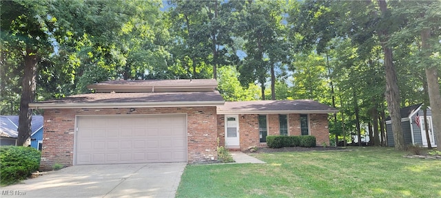 view of front of home with a front yard and a garage