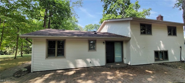 back of property featuring a chimney