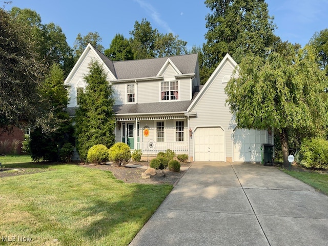 front of property featuring a porch, a front yard, and a garage