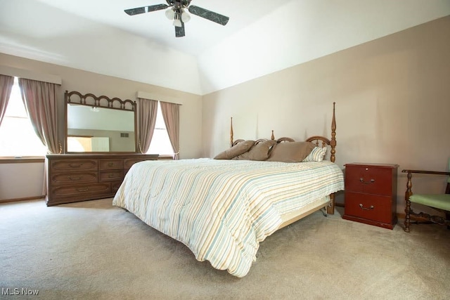 bedroom with multiple windows, ceiling fan, and light colored carpet