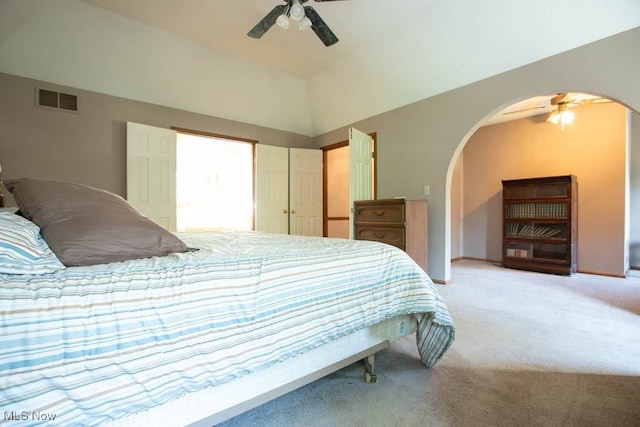 bedroom with light carpet, ceiling fan, and vaulted ceiling