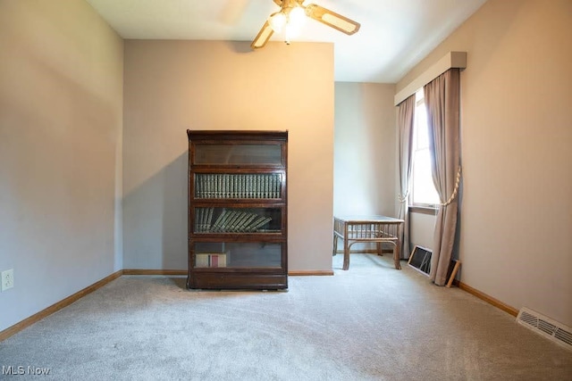 spare room featuring carpet floors and ceiling fan