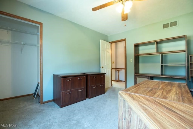 carpeted bedroom featuring ceiling fan and a closet