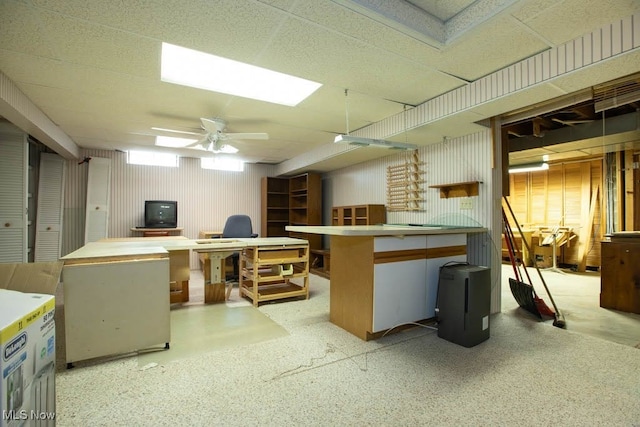 basement with a workshop area and ceiling fan