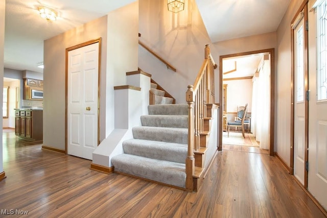 stairway with hardwood / wood-style flooring and a wealth of natural light