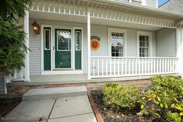 entrance to property featuring a porch