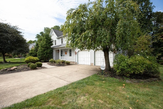 view of side of home featuring a garage, a lawn, and covered porch