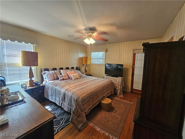 bedroom with dark wood-type flooring and ceiling fan