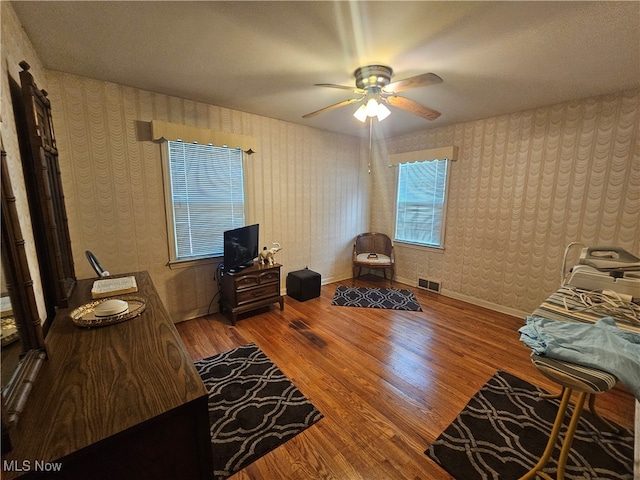 bedroom with ceiling fan and hardwood / wood-style floors