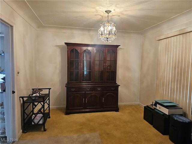 interior space with crown molding, an inviting chandelier, and light colored carpet