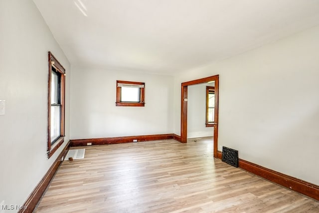 unfurnished room with light wood-type flooring