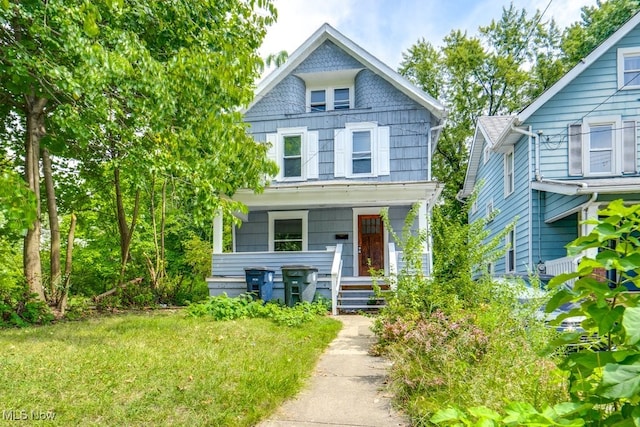 view of front of home with a front yard and covered porch