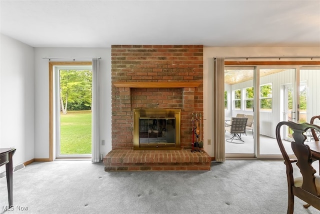 carpeted living room featuring a brick fireplace