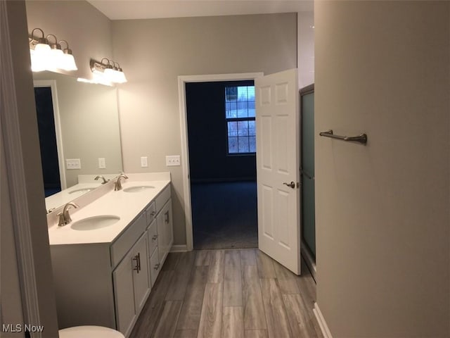 bathroom with hardwood / wood-style floors and vanity