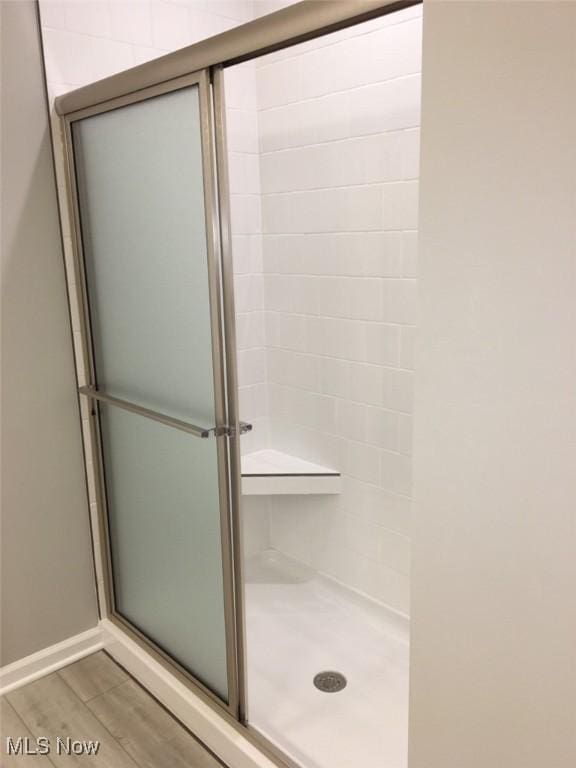 bathroom featuring walk in shower and hardwood / wood-style flooring