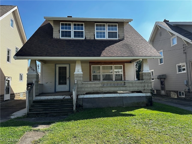 view of front of house with a porch and a front lawn