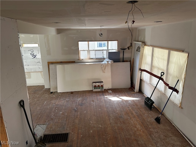 interior space with pendant lighting and hardwood / wood-style flooring