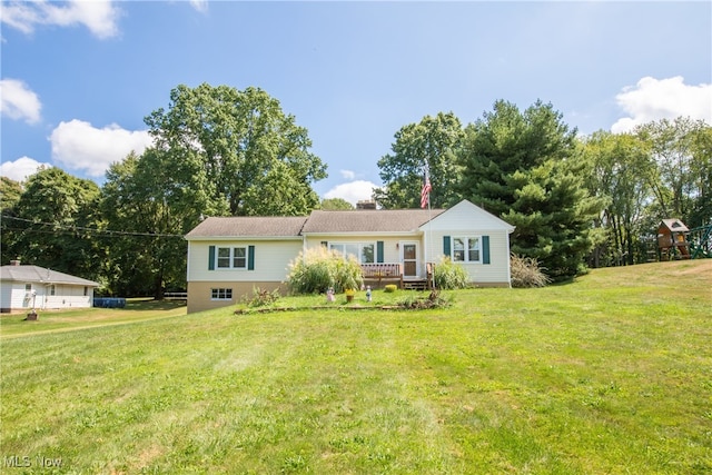 view of front of house with a front lawn and a wooden deck