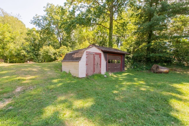 view of outdoor structure featuring a lawn