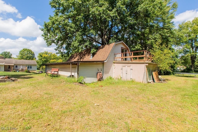 exterior space featuring a lawn and a wooden deck